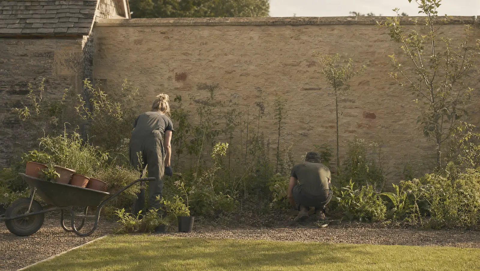 The Hartwell & Vale team planting a deep border, backs to the camera